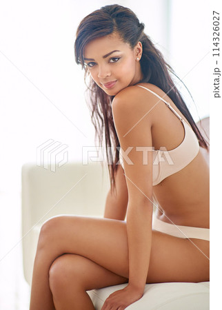 Shes the woman of your dreams. a gorgeous young woman posing seductively in her bedroom. Shes the woman of your dreams. a gorgeous young woman posing seductively in her bedroom. 114326027