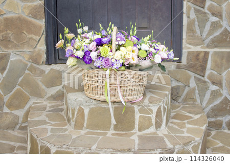 a basket of flowers on the steps in front of the front door a basket of flowers on the steps in front of the front door 114326040