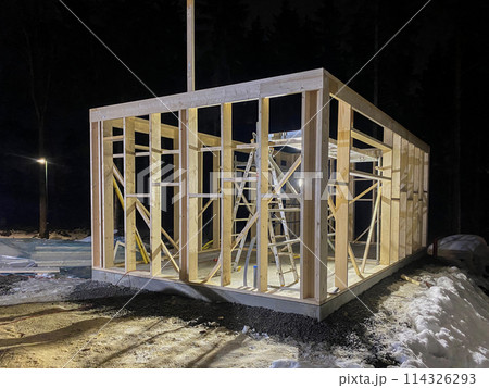 Wooden frame of a house under construction on a universal Swedish plate 114326293