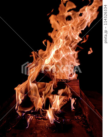 flames when burning firewood on a black background flames when burning firewood on a black background 114326334