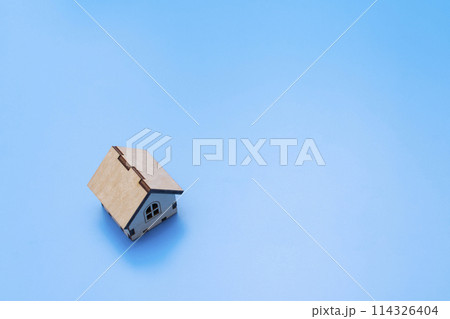 small toy wooden house on a blue background 114326404
