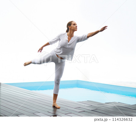 Yoga, woman and pool deck outdoor with balance, peace and calm by water with zen at home. Wellness, health and female person on a patio with stretching, pilates and spiritual practice at a house 114326632