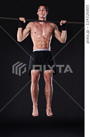 Man, bar and pull up for arm exercise in studio for bicep training or muscle building, gym or workout. Male person, fitness and black background for bodybuilding performance, wellness or mockup space 114326805