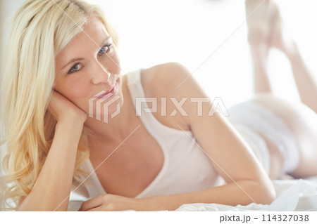 Relax, carefree and portrait of girl on bed with smile, morning health or wellness on weekend in home. Wake up, underwear and happy woman in bedroom for rest, comfort or fresh start to day in Norway 114327038
