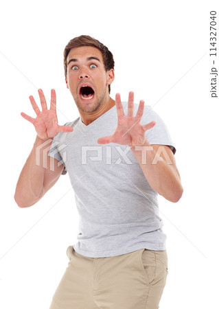 Shocked, scared and portrait of man on a white background for surprise, horror and fear reaction. Shouting, screaming and isolated person with hand gesture for terror, anxiety and afraid in studio 114327040