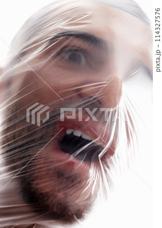 Man, plastic and bag in choking, depression and mania with air in white background. Male person, expression and suffocating in crisis for awareness, help and anxiety in mental health or wellness Man, plastic and bag in choking, depression and mania with air in white background. Male person, expression and suffocating in crisis for awareness, help and anxiety in mental health or wellness 114327576