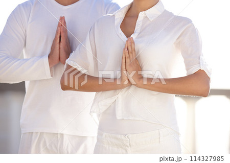 Hands, namaste and calm couple at yoga retreat with balance, peace and relax in mindfulness at outdoor resort. Zen, man and woman in meditation for holistic health, spiritual wellness and prayer pose Hands, namaste and calm couple at yoga retreat with balance, peace and relax in mindfulness at outdoor resort. Zen, man and woman in meditation for holistic health, spiritual wellness and prayer pose 114327985