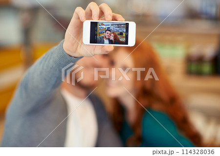Couple, selfie and hand with smartphone, screen and profile picture of man and woman together in cafe. Happy people, portrait and photography on cellphone for social media or smile in relationship 114328036