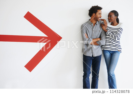 Couple, love and happiness with arrow by wall in car park with mockup space and romance with smile. African people, embrace and arms crossed in parking area with direction, sign and symbol of icon Couple, love and happiness with arrow by wall in car park with mockup space and romance with smile. African people, embrace and arms crossed in parking area with direction, sign and symbol of icon 114328078