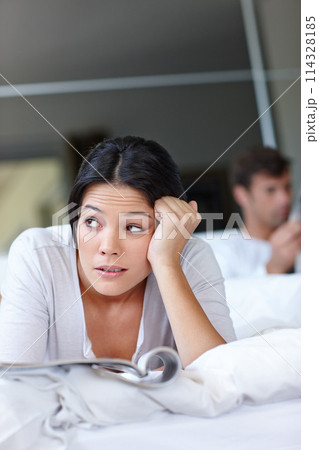 Woman, annoyed and bed with magazine and boyfriend for thinking, couple or angry for breakup or argument in home. Mexican female person and frustrated with thought for stress mindset with partner Woman, annoyed and bed with magazine and boyfriend for thinking, couple or angry for breakup or argument in home. Mexican female person and frustrated with thought for stress mindset with partner 114328185
