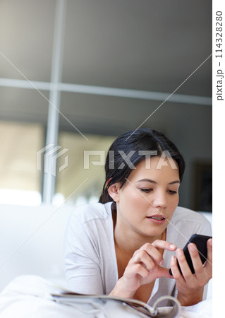 Woman, smartphone and check text in bedroom for social media, technology and internet communication. Female person, mobile phone and looking online in house for magazines, website and search 114328280