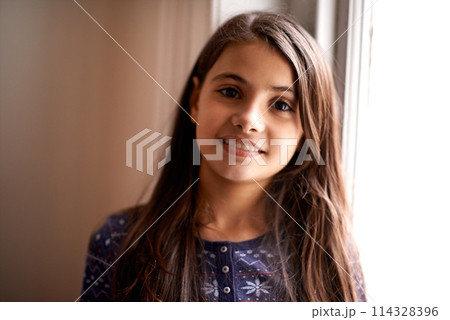 Young girl, kid and smile in portrait, happy at home with childhood and development, positive mood and innocent. Youth, preteen and female child for growth, relax at family house with confidence 114328396