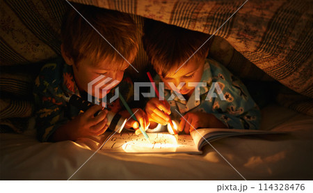 Flashlight, blanket and children at night with happiness in dark with drawing in a book. Friends, relax and sketch on notebook with torch or light under duvet at sleepover with a pillow tent Flashlight, blanket and children at night with happiness in dark with drawing in a book. Friends, relax and sketch on notebook with torch or light under duvet at sleepover with a pillow tent 114328476
