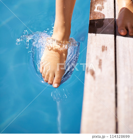 Wet, feet and pool in splash, outdoor and backyard for summer day and relaxation to swim in heat. Toes, outside and wet in holiday, backyard and resort for fun in the sun on vacation at home 114328699