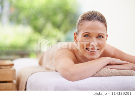 Happy woman, portrait and relax with massage for spa, zen or relaxation at hotel or outdoor resort. Face of female person with smile, enjoying facial or body treatment at accommodation for wellness 114329291