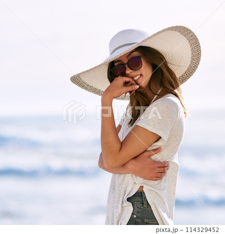 Sunglasses, smile and portrait of woman at beach for summer vacation, travel and adventure in Miami. Outdoor, happy and relax by ocean with hat for tourism, weekend trip and confidence on holiday 114329452