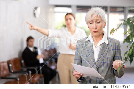 Young woman chief screaming to mature female manager during working Young woman chief screaming to mature female manager during working 114329554