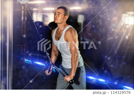 Young man training with straps in gym Young man training with straps in gym 114329576