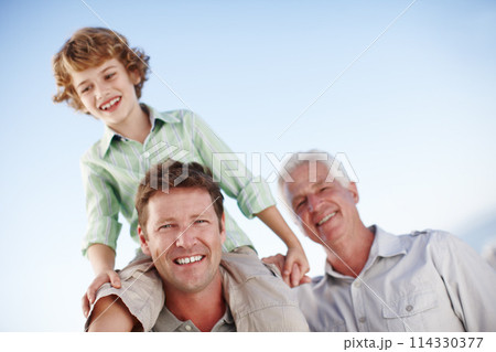 Portrait of grandfather, father and child by blue sky for bonding, relationship and relax together. Family, generations and grandpa, dad and young boy on shoulders for holiday, vacation and weekend 114330377