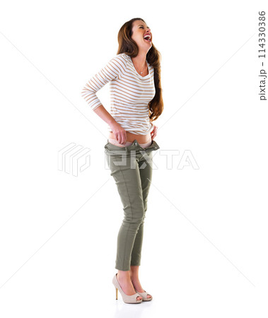 Woman, fashion and laugh in studio for casual, pants and cool clothes on white background. Female person, smile and jeans with humour, happiness and comedy on backdrop for apparel and mockup space 114330386