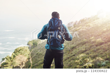 Backpack, hiking and mountain with man, nature and sunshine with environment, wellness and training. Rear view, hiker and person with hiking, healthy and travel with adventure, journey and vacation 114330422