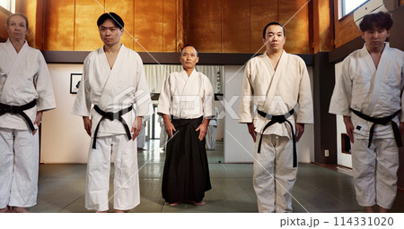 Japanese students, bow or learning aikido in dojo, training and modern martial arts for self defence or respect. Group, black belt class and sensei in instruction, honor and discipline in commitment 114331020