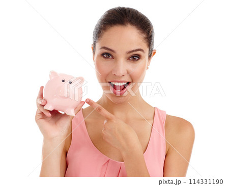 Portrait, woman and pointing at piggy bank in studio for budget, finance or investment. Face, excited or person with money box for savings, income or security of profit isolated on a white background Portrait, woman and pointing at piggy bank in studio for budget, finance or investment. Face, excited or person with money box for savings, income or security of profit isolated on a white background 114331190
