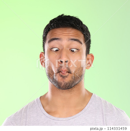 Man, play and silly in studio, face and goofy comic or funny expression on green background. Male person, mockup space and guy for joke or comedy, student and humor for crazy character and quirky Man, play and silly in studio, face and goofy comic or funny expression on green background. Male person, mockup space and guy for joke or comedy, student and humor for crazy character and quirky 114331459