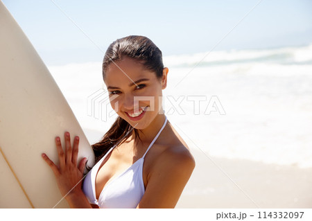 Woman, ocean and surfboard for surfing or portrait with bikini, adventure and fitness with blue sky. Tourist, person and surfer by beach in morning for holiday, vacation or mockup space in California 114332097