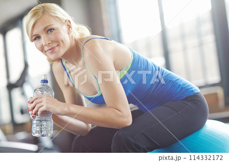 Portrait, ball or woman drinking water on break in exercise, workout or fitness training in gym. Relax, healthy girl or thirsty sports athlete with smile or bottle for wellness, rest or hydration 114332172