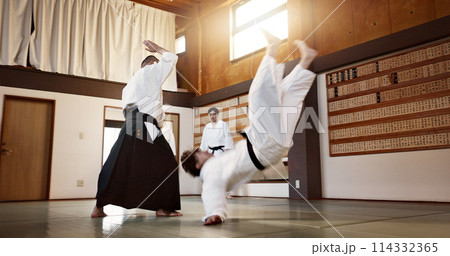 People, dojo and sensei with student in self defense or training for fight or challenge with master. Man, teacher and martial arts class in Japan for practice lesson, aikido or team battle in Tokyo 114332365