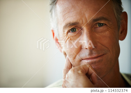 Headshot, senior man and portrait thinking about retirement at home, apartment and living room with mockup space. Hand, idea and mature male person in house to relax in lounge for elderly care 114332374