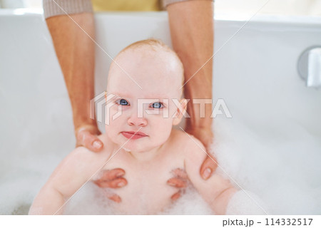 Soap, bubbles and portrait of baby in bath for cleaning, washing and hygiene with parents in home. Family, bathroom and newborn infant in bathtub, foam and water for wellness, health and childcare Soap, bubbles and portrait of baby in bath for cleaning, washing and hygiene with parents in home. Family, bathroom and newborn infant in bathtub, foam and water for wellness, health and childcare 114332517