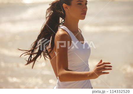 Woman, running and beach with fitness for workout, training or outdoor exercise in nature. Active and young female person or athlete enjoying run, cardio or physical activity on the ocean coast Woman, running and beach with fitness for workout, training or outdoor exercise in nature. Active and young female person or athlete enjoying run, cardio or physical activity on the ocean coast 114332520