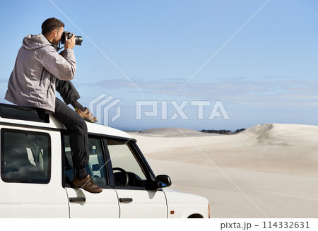 Road Trip, dunes and man in nature for photography, desert landscape and travel for holiday. Pictures, 4x4 and nomad male person in Sahara terrain, outdoor and transport in dry climate and scenery 114332631