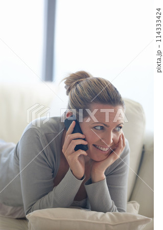 Thinking, happy woman or phone call on couch in home talking or speaking in living room for communication. Ideas, mobile or person with smile in conversation to relax on sofa in a house for a break 114333424