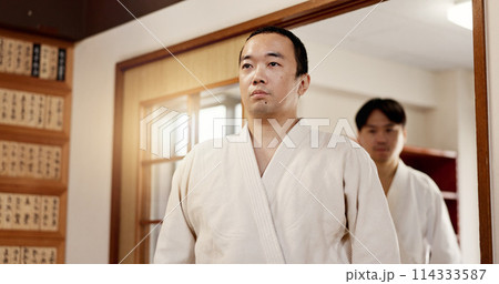 Aikido student, ready or men in dojo to start practice, discipline or self defense education in Japan. Master, people learning sports or athletes walking in fighting class, lesson or training 114333587