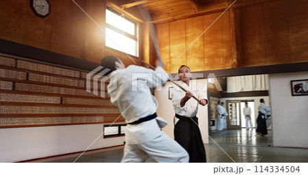 Aikido men, fight and bokken for martial arts, weapon or contest for black belt students at training, gym or dojo. Japanese people, wood sword and sensei for exercise, workout and fitness in battle Aikido men, fight and bokken for martial arts, weapon or contest for black belt students at training, gym or dojo. Japanese people, wood sword and sensei for exercise, workout and fitness in battle 114334504