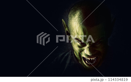 Monster, man and devil face in studio for fantasy, horror and angry vampire with fangs, scary and terror. Werewolf, demon and creepy creature with mockup, rage and surreal alien on black background 114334819