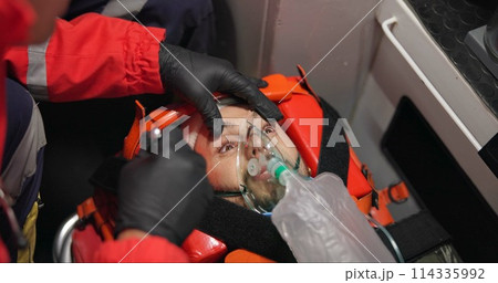Man, patient and paramedic in first aid with flashlight, eyes and emergency with medicine and injured. Victim, accident and ems of 911 with oxygen mask, medical service and healthcare to hospital Man, patient and paramedic in first aid with flashlight, eyes and emergency with medicine and injured. Victim, accident and ems of 911 with oxygen mask, medical service and healthcare to hospital 114335992