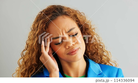 Frustrated woman, headache and stress with anxiety, mental health or depression on a gray studio background. Face of tired female person in fatigue, pressure or tension with overwhelmed emotion 114336094