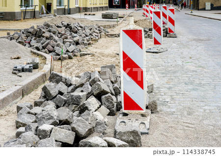 Street paving with historical hammered granite paving stones, city street surface restoration Street paving with historical hammered granite paving stones, city street surface restoration 114338745
