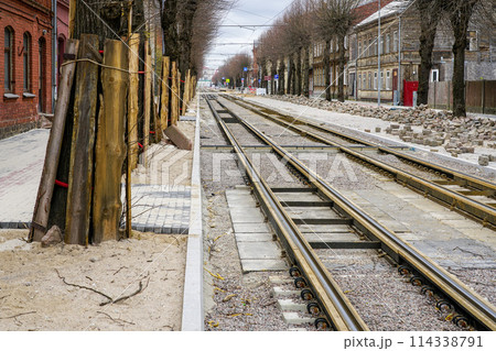 Street reconstruction, tree trunks with board protectors, newly replaced tram tracks and pavement 114338791