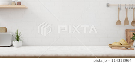 A space on a white marble kitchen tabletop with minimalist kitchen utensil against the white wall. 114338964