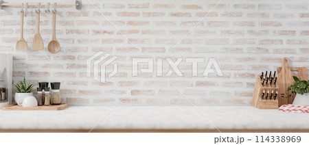 A display space on a white kitchen tabletop against the brick wall in a minimalist farmhouse kitchen 114338969
