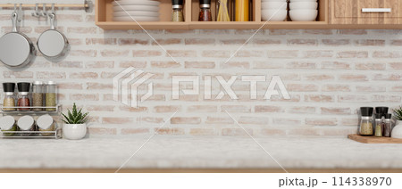 A display space on a white kitchen tabletop against the brick wall in a minimalist farmhouse kitchen 114338970