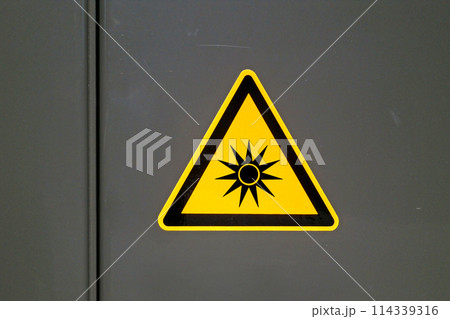Optical radiation sign on a metal door Optical radiation sign on a metal door 114339316