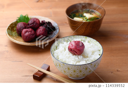 ご飯にのせた昔ながらの酸っぱい梅干し ご飯にのせた昔ながらの酸っぱい梅干し 114339552