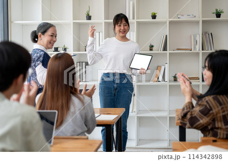 A young Asian female college student is presenting her project in the classroom. A young Asian female college student is presenting her project in the classroom. 114342898