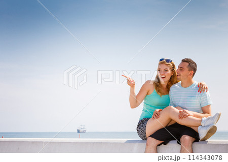 Man and woman sitting together outside 114343078